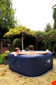 2 guys chilling in a hot tub